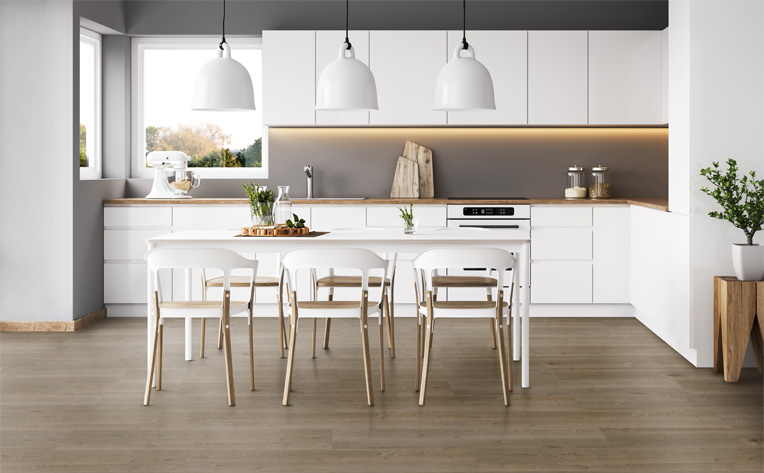 luxury vinyl plank flooring in kitchen with white cabinets and dining table.