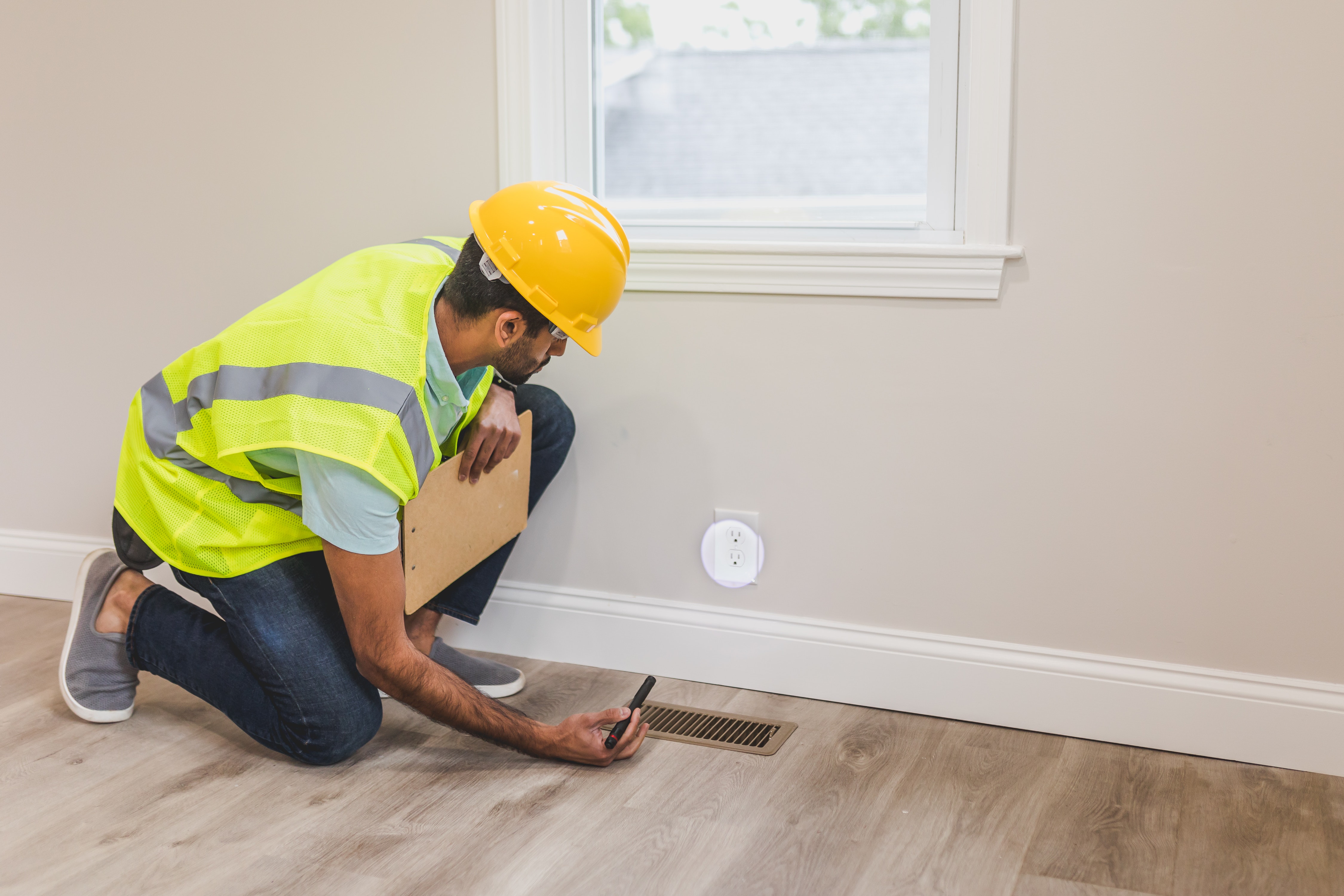 Stock photo of installer working on floors and walls. 